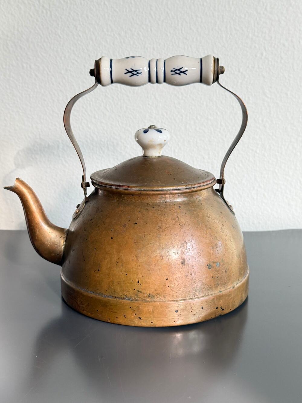 Vintage copper tea kettle with hand-painted blue and white porcelain handle lid